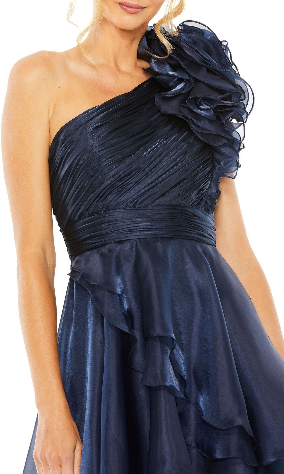 A woman wears the Short Wedding Guest Dress 49527 by Mac Duggal, featuring midnight blue fabric, a one-shoulder ruffled detail, and a fitted, ruched bodice perfect for parties.
